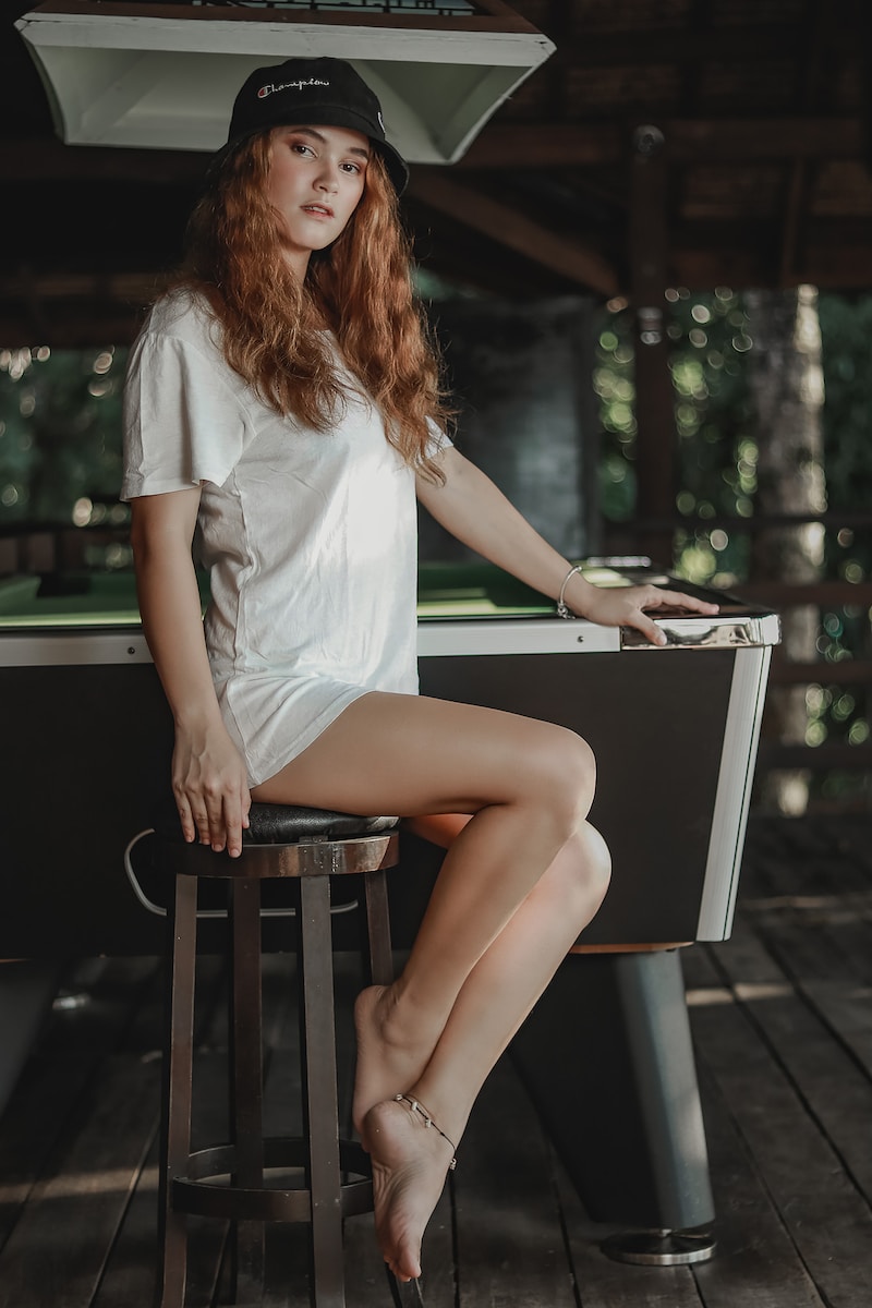 woman in white shirt sitting on black chair